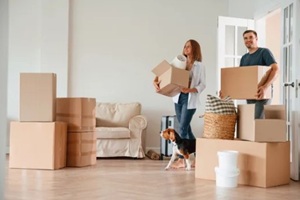 young couple with dog are moving to new home